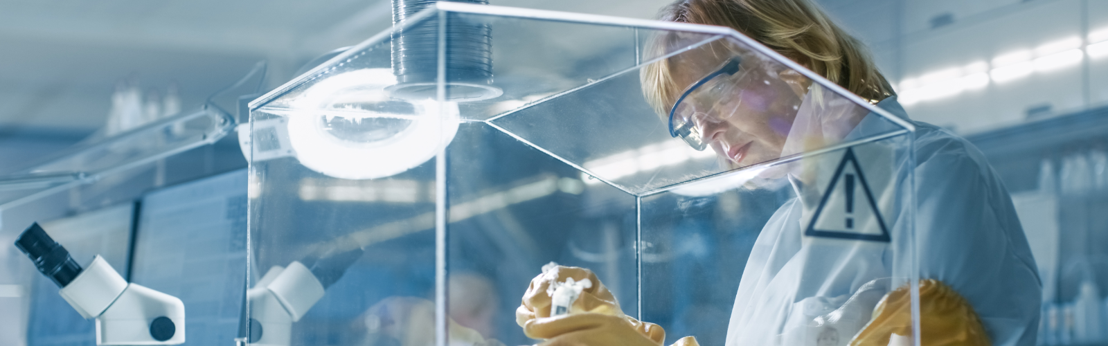 Lab technician safely examining materials
